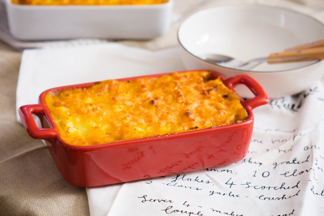 Shepherd's Pie in a baking dish on top of a handwritten recipe