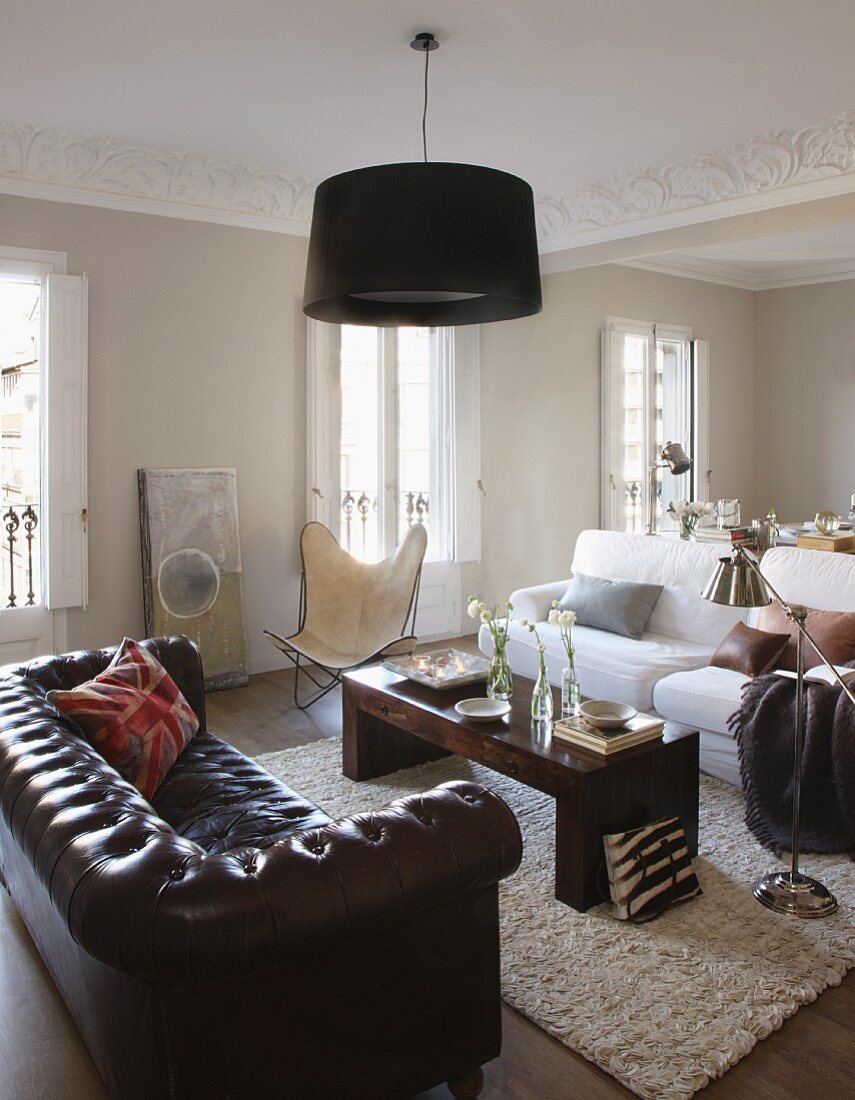 Seating area with leather sofa, Butterfly easy chair and white sofa