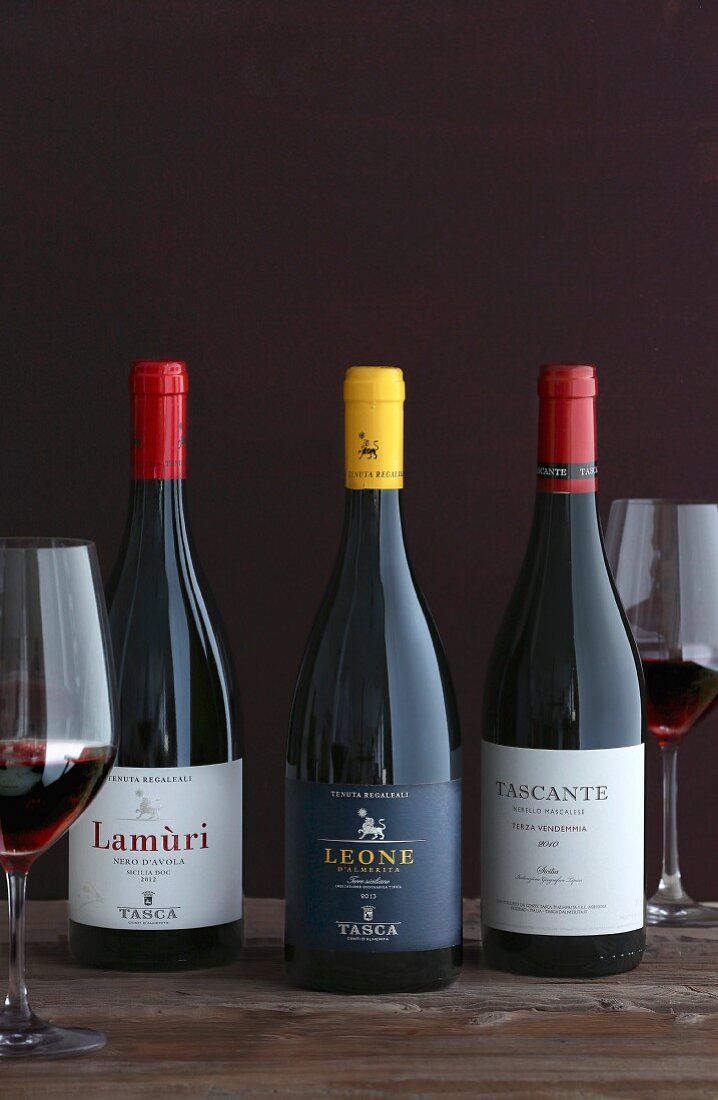 Various bottles of wine from Italy: Lamuri Nero d’ Avola (2012), Leone d’ Almerita (2013), Tascante Terza Vendemmia (2010)