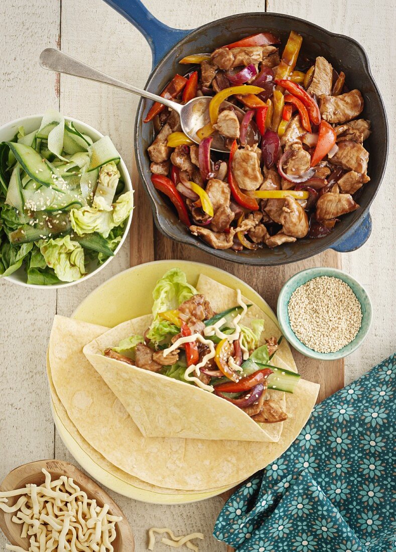 Teriyaki pork in a pan and wrap served with salad