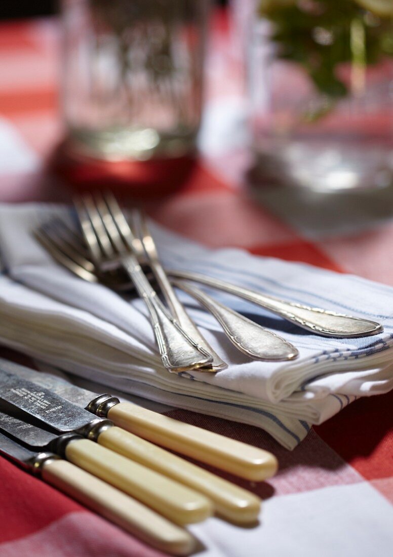 Cutlery and fabric napkins on a rustic table