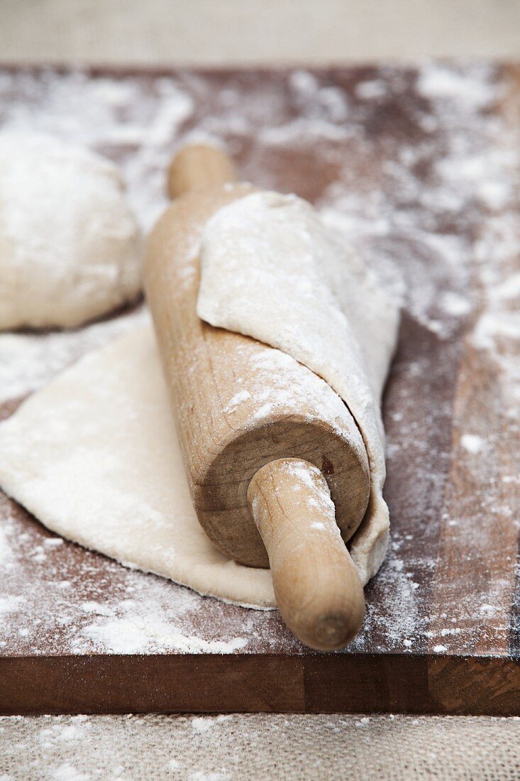 Rolled out pizza dough with a rolling pin