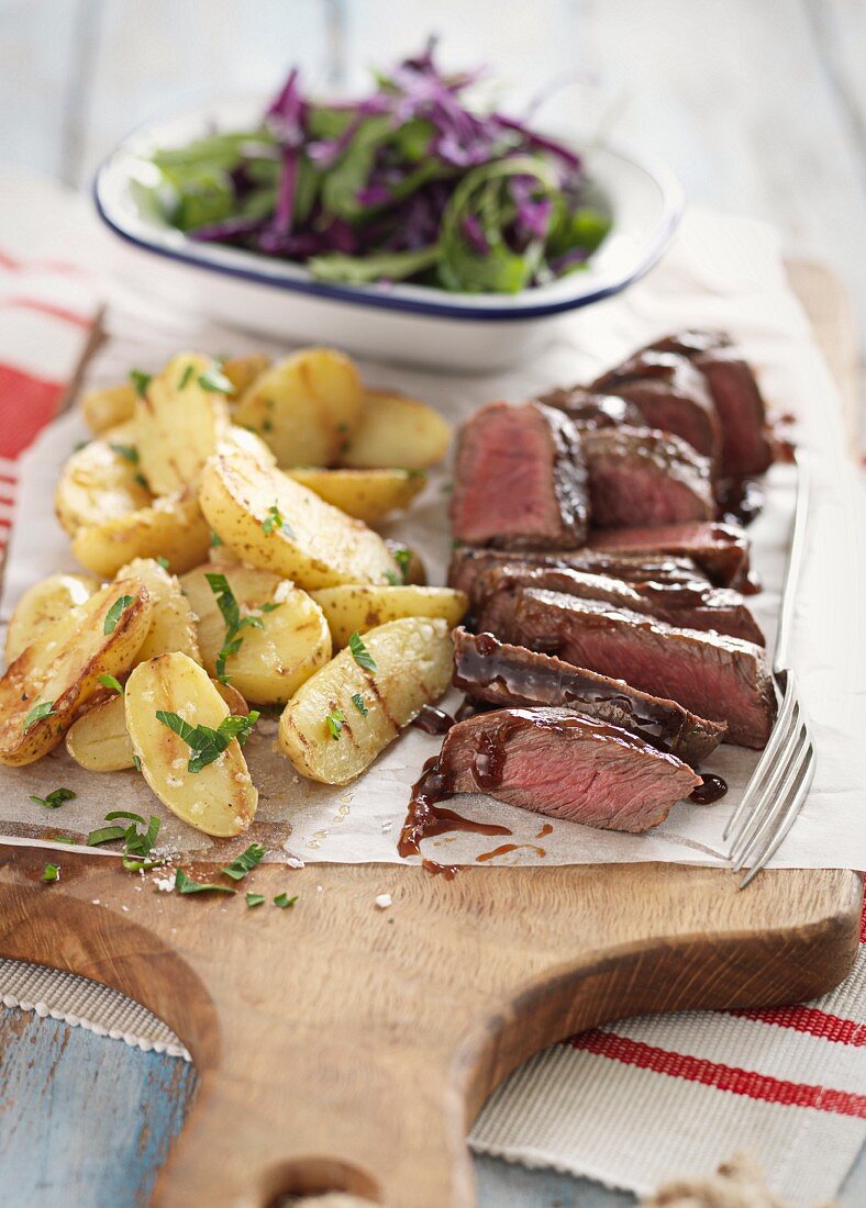 Grilled venison steak with potatoes