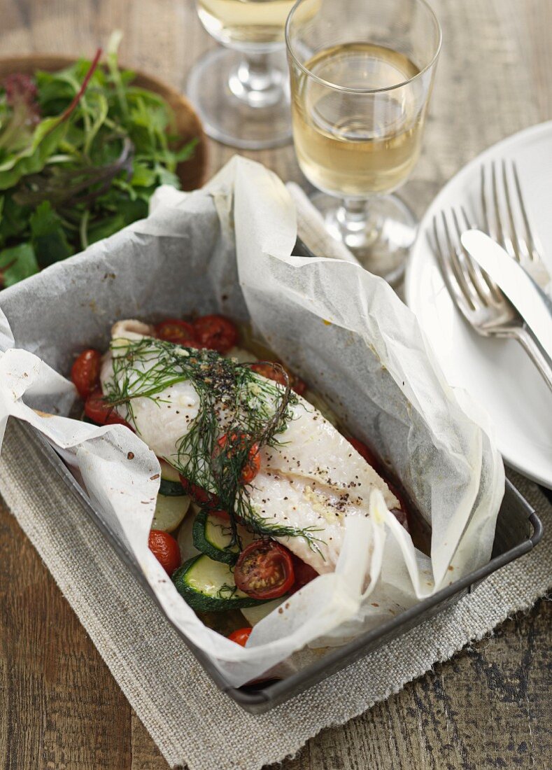 Gebackener Fisch mit Zucchini und Tomaten im Pergamentpapier