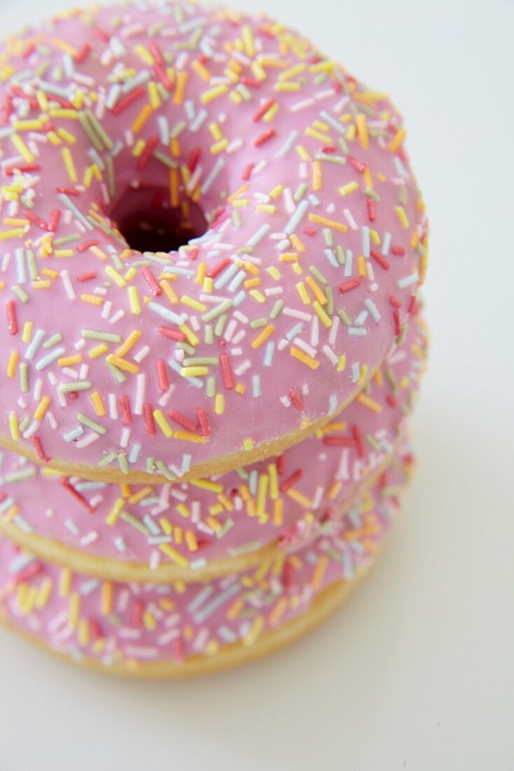 Pink iced doughnuts with sugar sprinkles