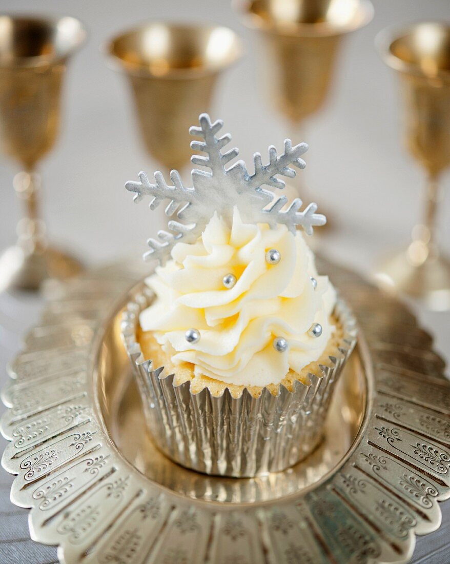 A festive Christmas cupcake with a silver fondant snowflake