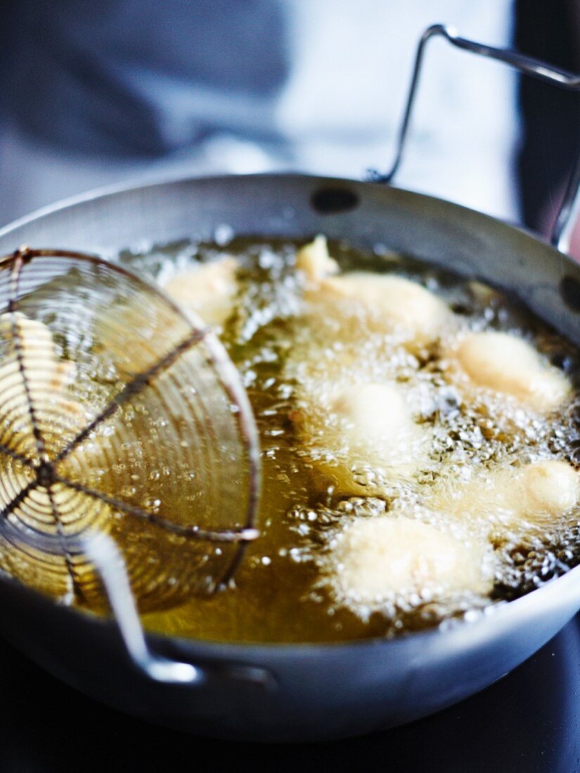 Battered fish being fried