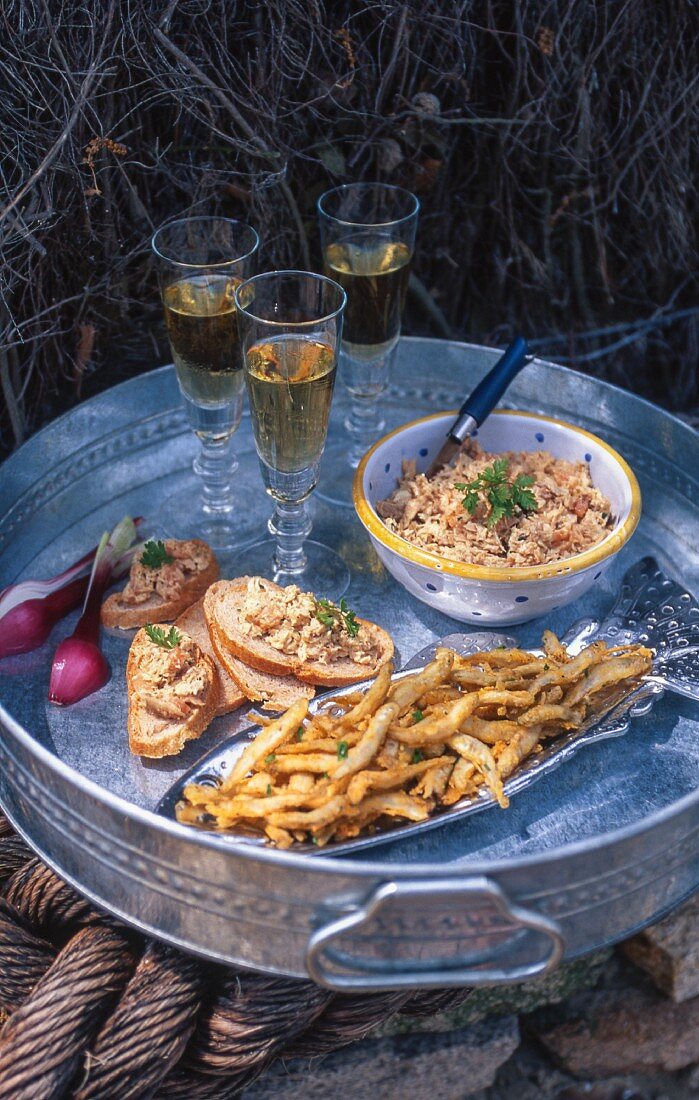 Fried smelts, spreads and wine on a tray
