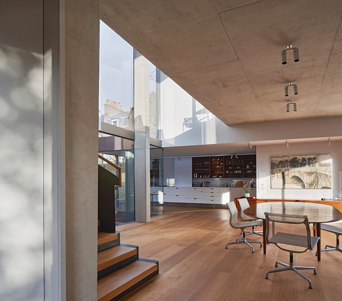 Open plan living and kitchen area with glass walls