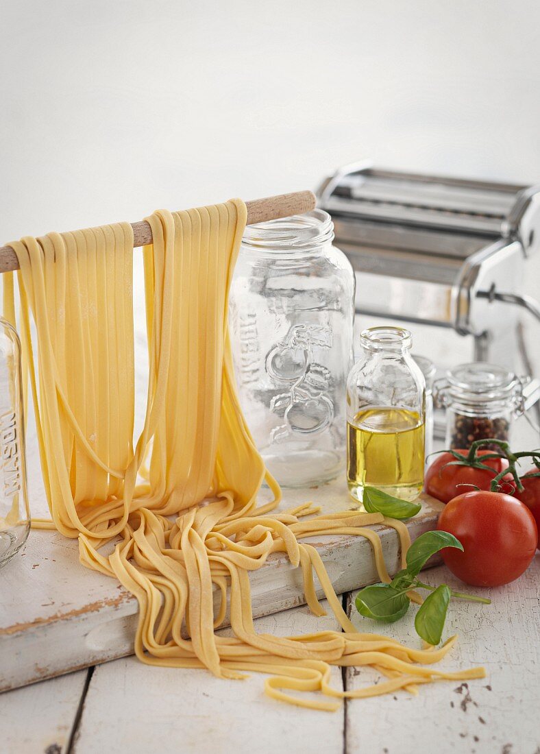 Homemade pasta, tomatoes, olive oil, spices and pasta machine