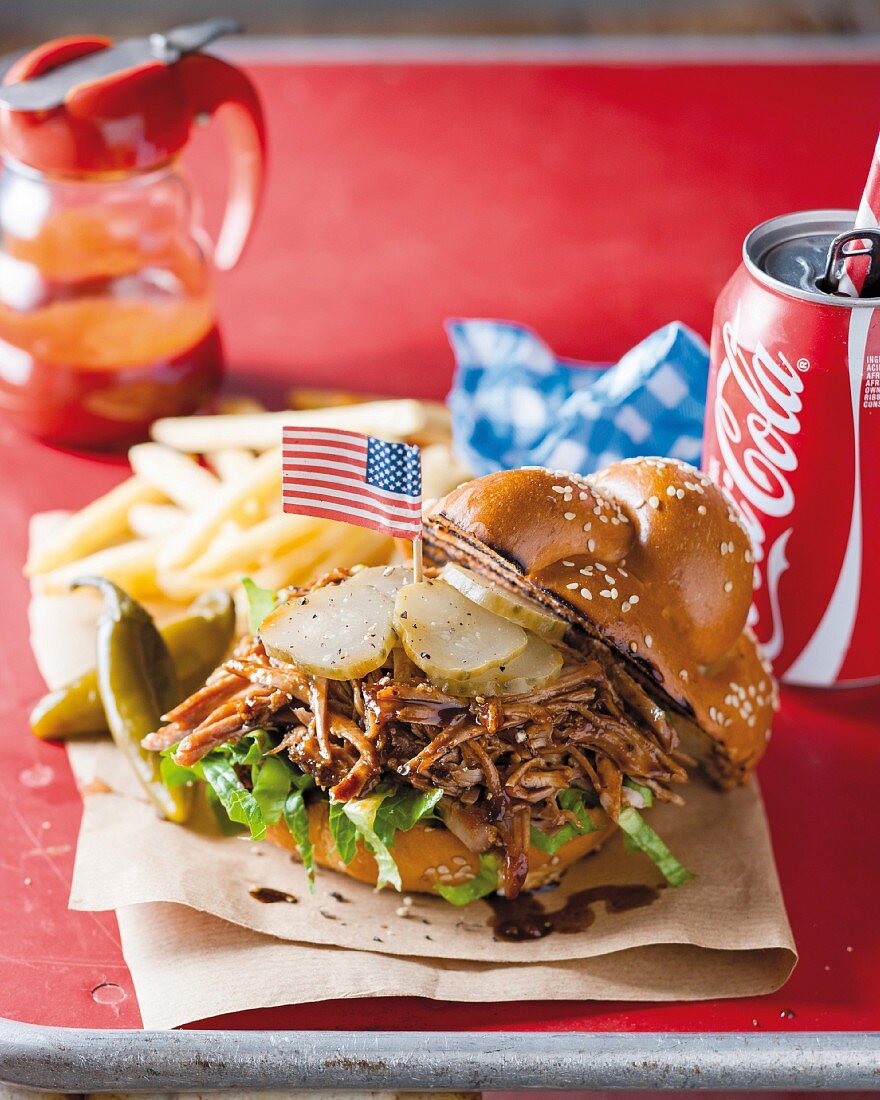 A pulled pork sandwich with cola