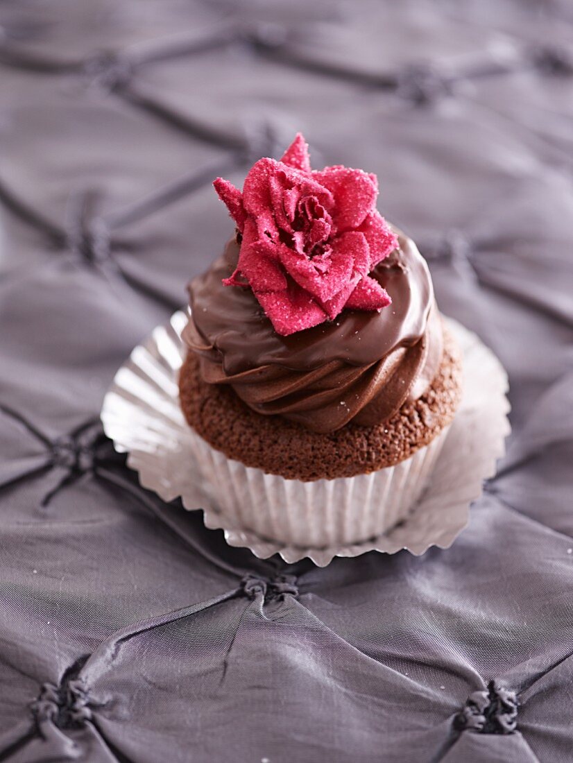 A Valentines cupcake decorated with a sugar rose