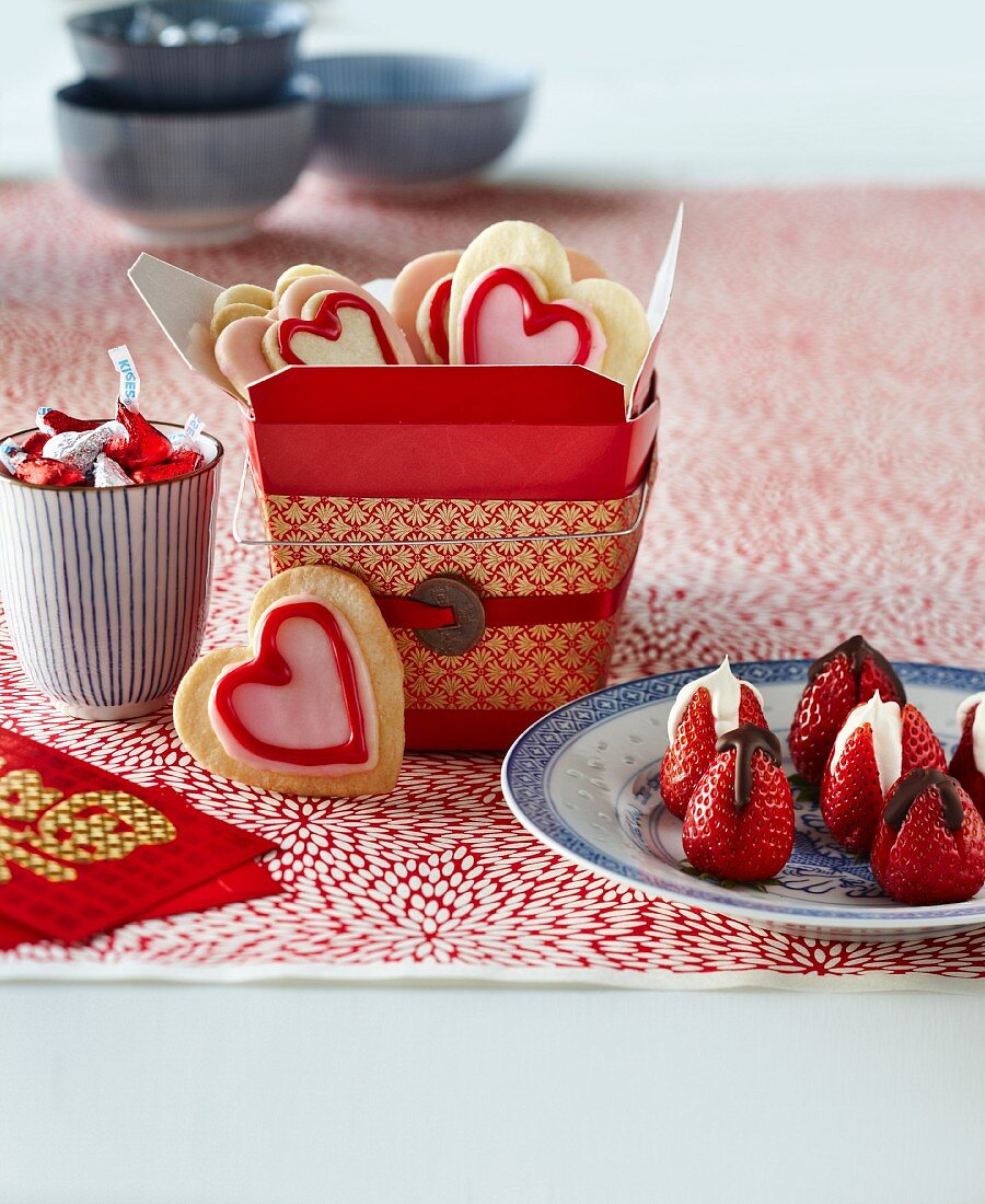 Heart-shaped biscuits, chocolate strawberries and pralines for Valentine's Day