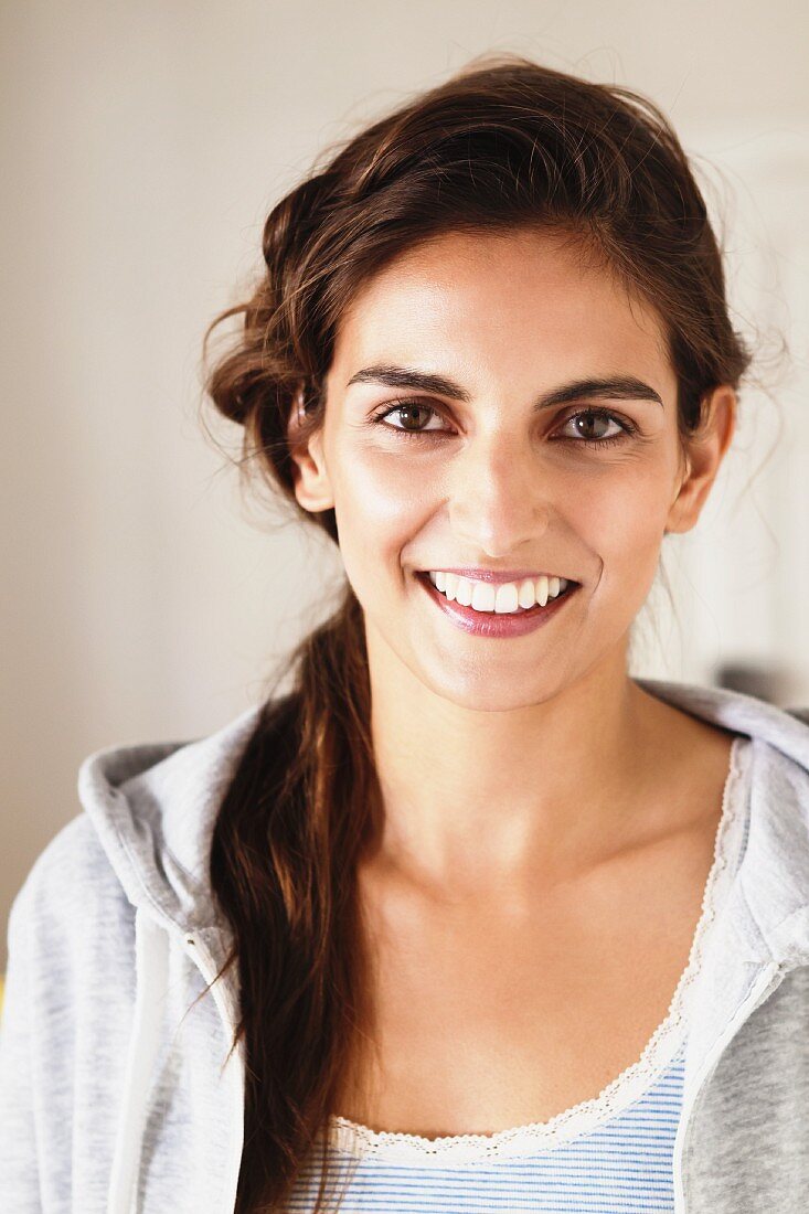 Young, brunette woman wearing hooded sweater