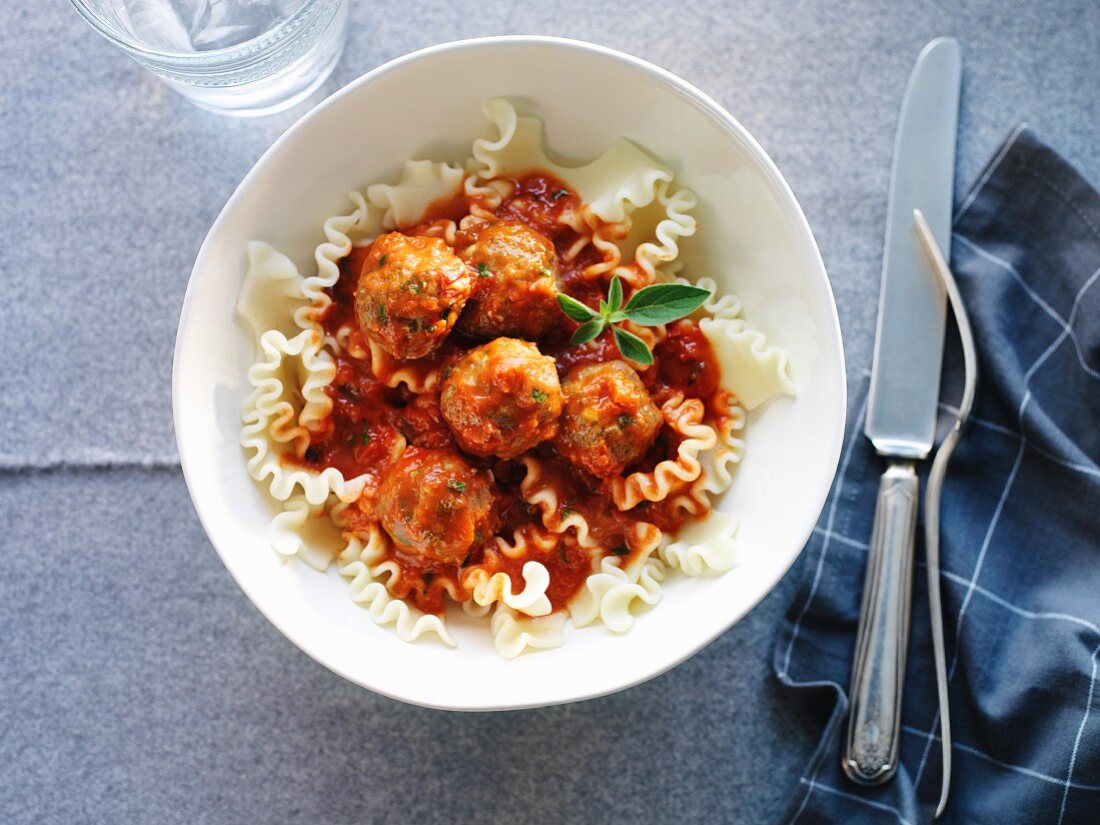 Meatballs with Parmesan cheese, pasta and tomato sauce