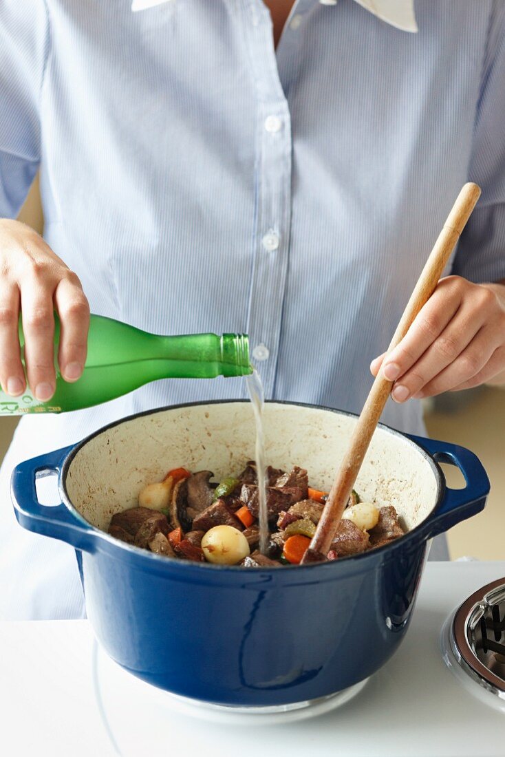 Sake being poured over beef stew