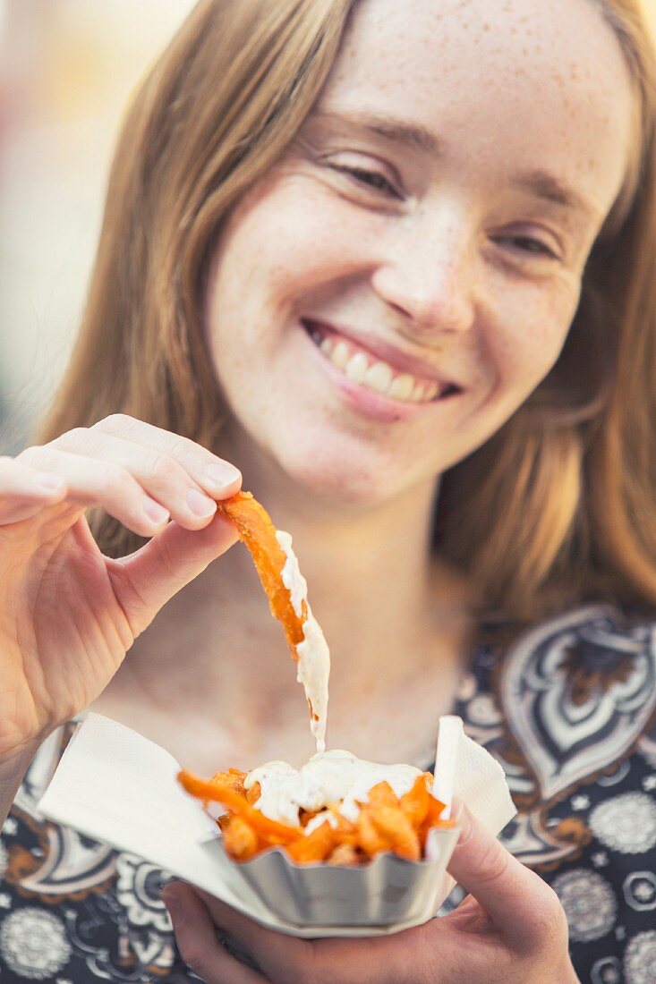 A young woman with sweet potato fries
