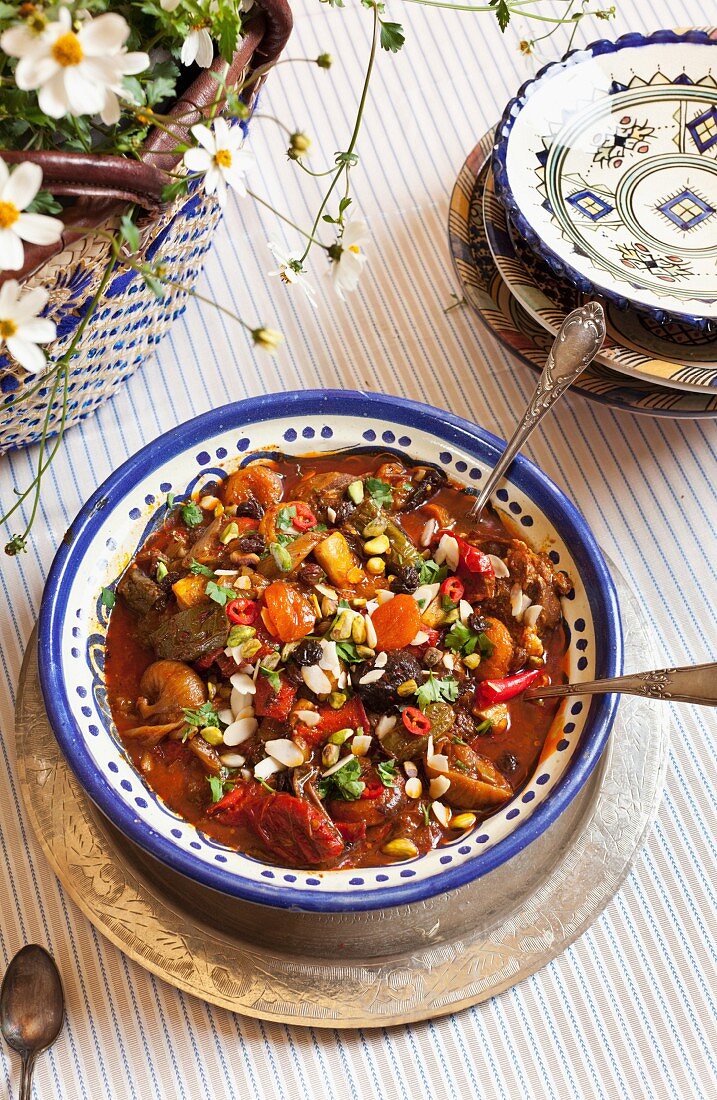 Braised beef tagine with raisins, figs, okra, peppers, ground pepper, coriander, pistachios and almonds (Morocco)