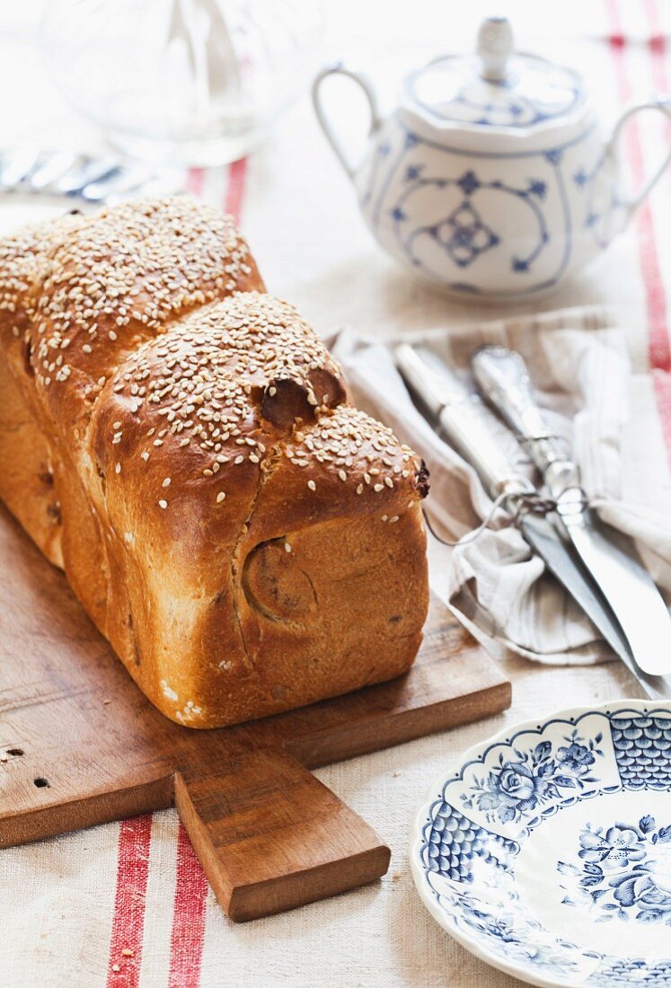 Challah with sesame seeds on a chopping board