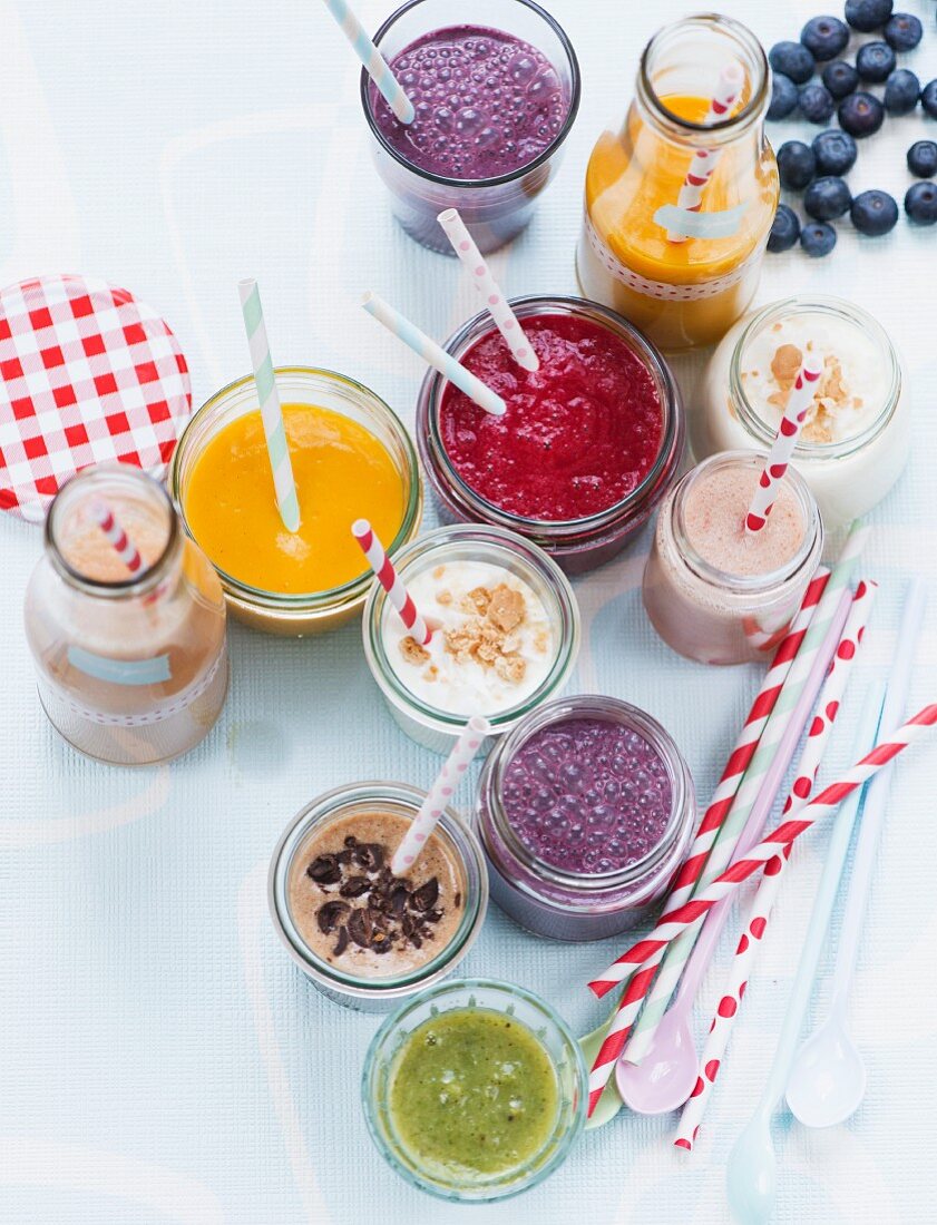 Various smoothies in glasses and bottles