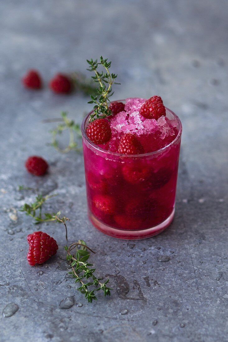 A raspberry cocktail with vodka, fresh thyme and crushed ice