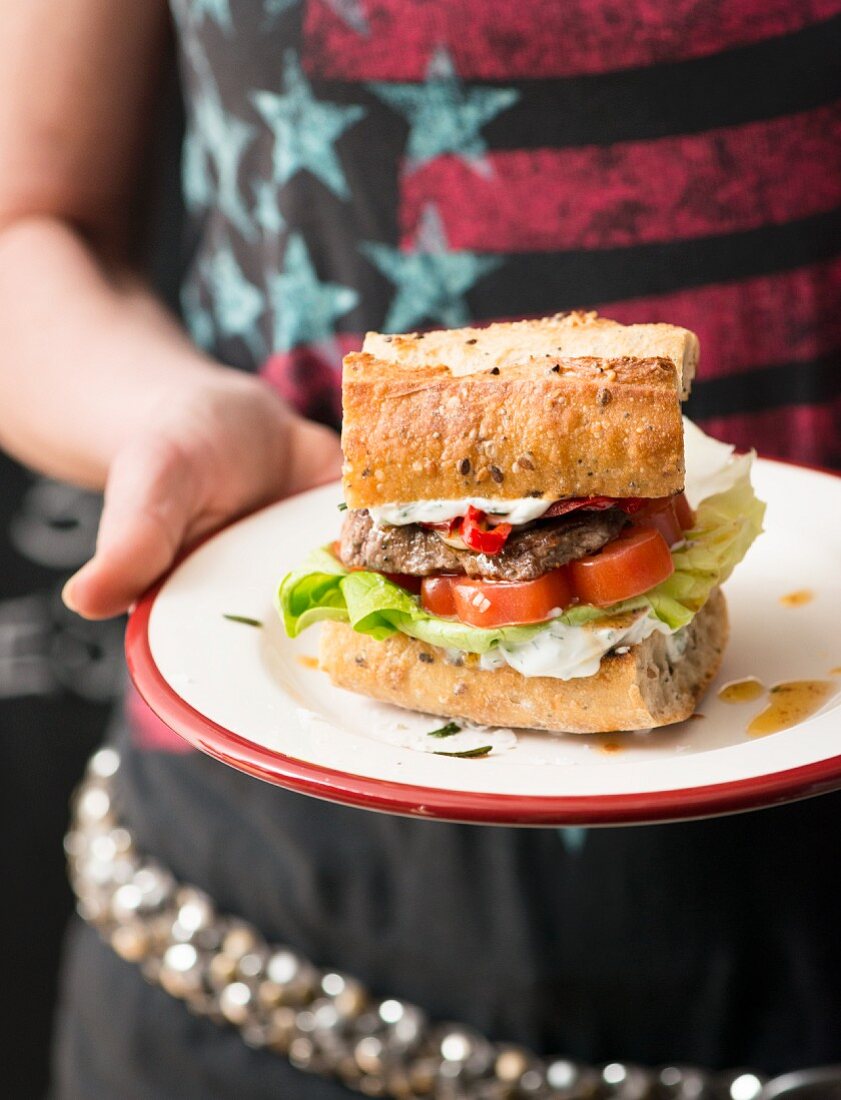 A barbecue burger with pesto in a diner