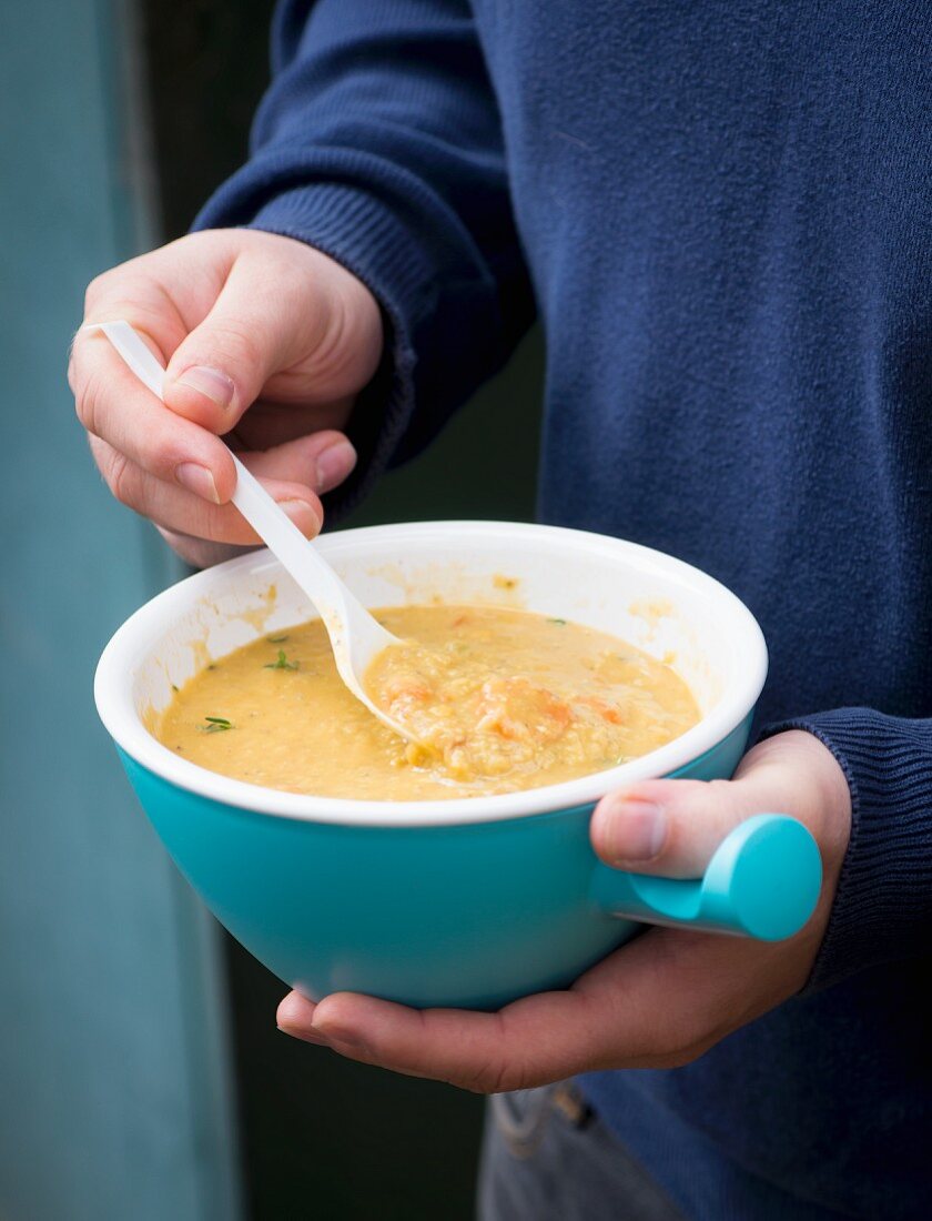 A man eating lentil soup