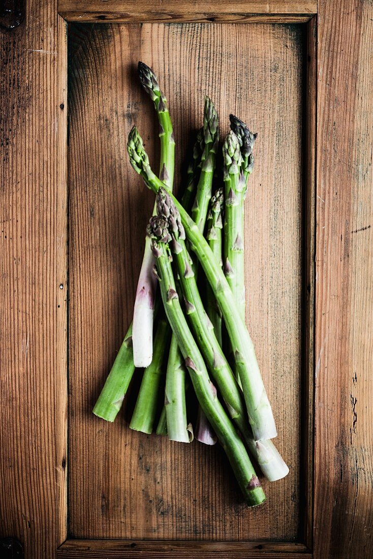 Green asparagus on a rustic wooden surface