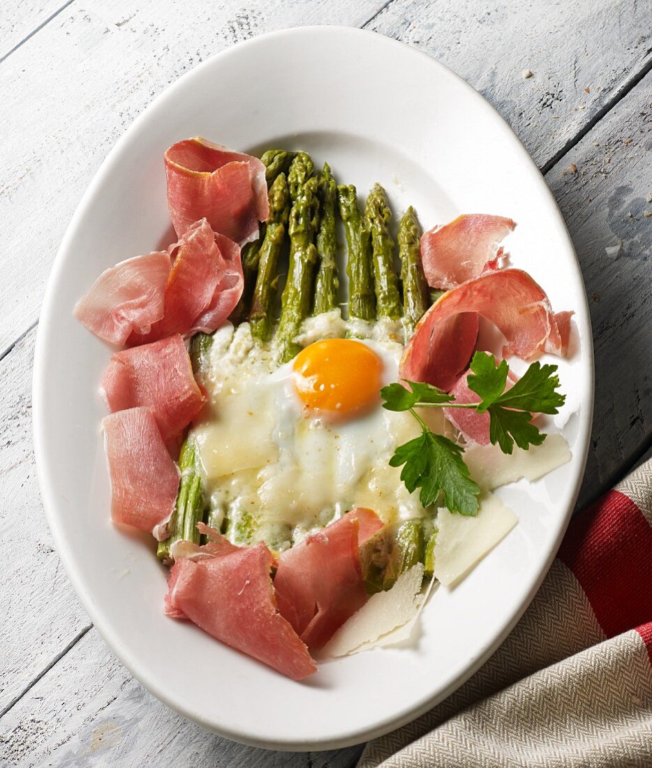 Green asparagus topped with melted Parmesan served with Parma ham and a fried egg