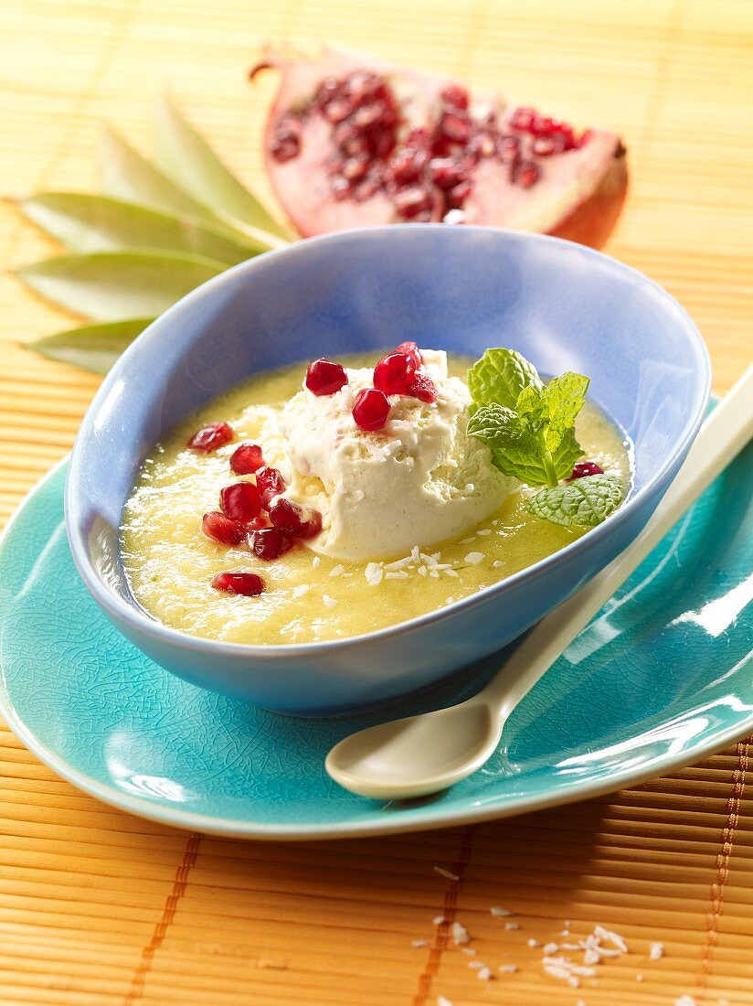 Pineapple soup with coconut ice cream and pomegranate seeds