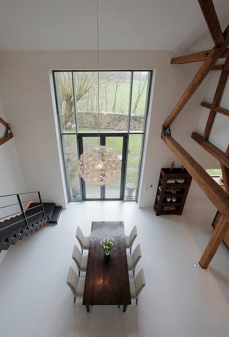 Dining area with high ceilings and views of the yard