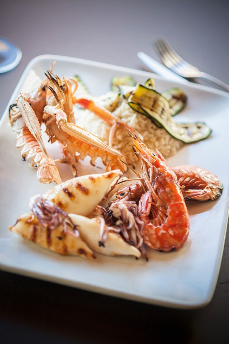 A grill platter featuring squid, prawns and langoustines