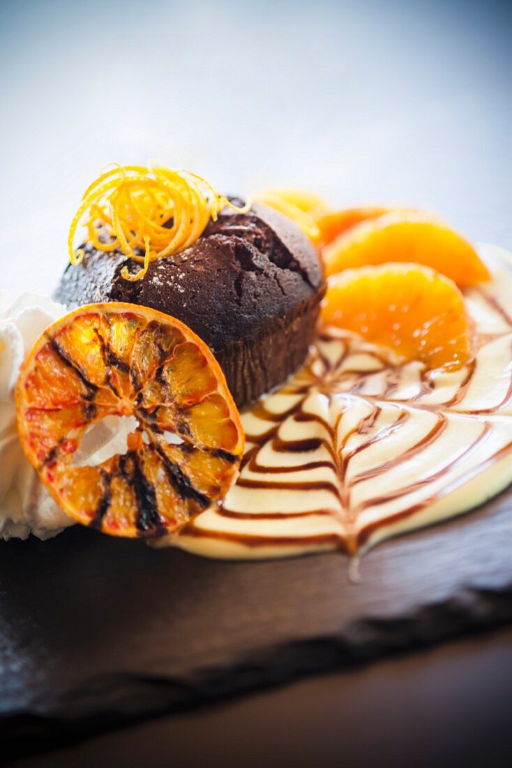 Chocolate orange cake on orange cream with whipped cream