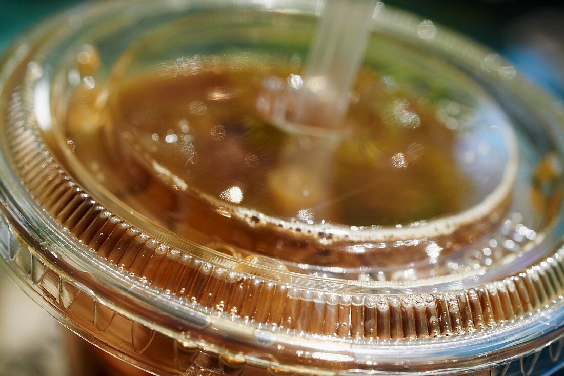 Iced coffee in a takeaway cup (close-up)