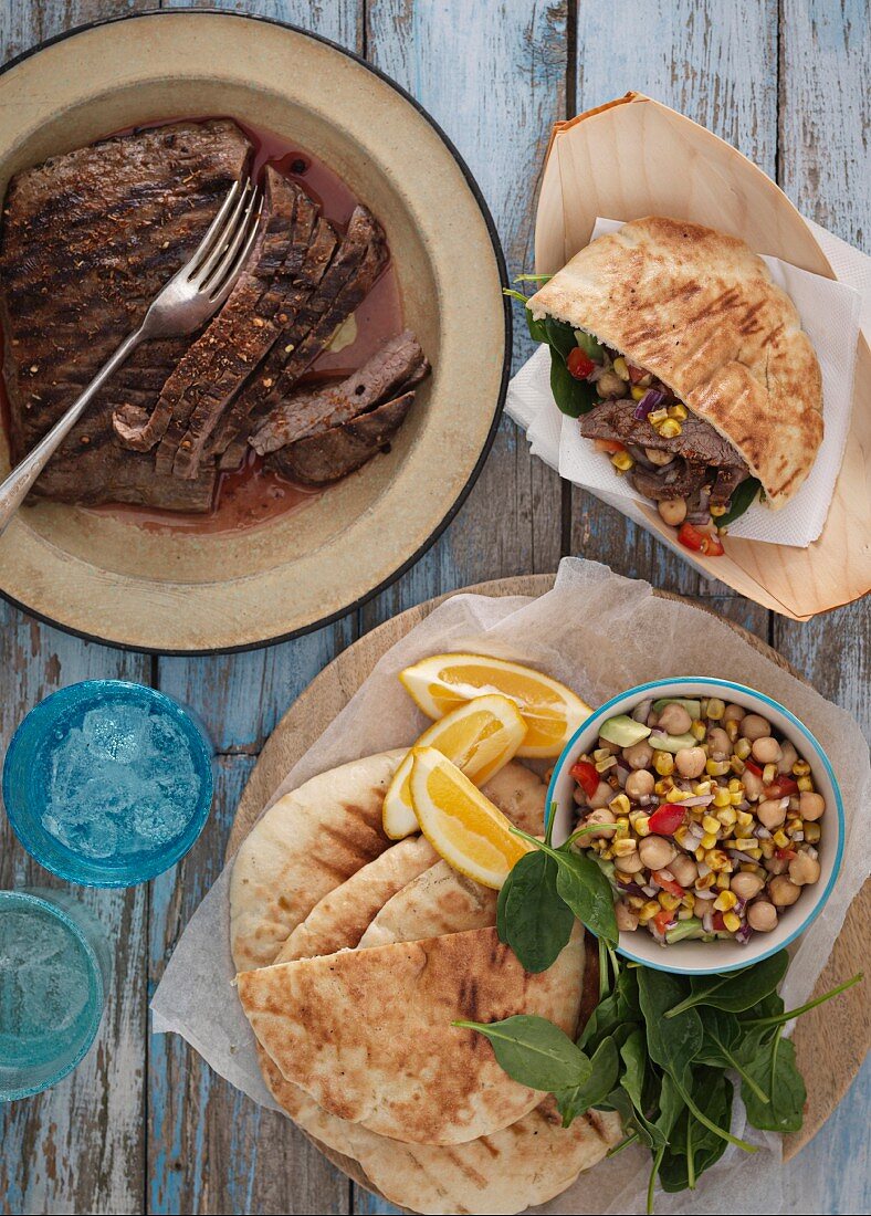 Grilled steak, pita bread and a chickpea salad