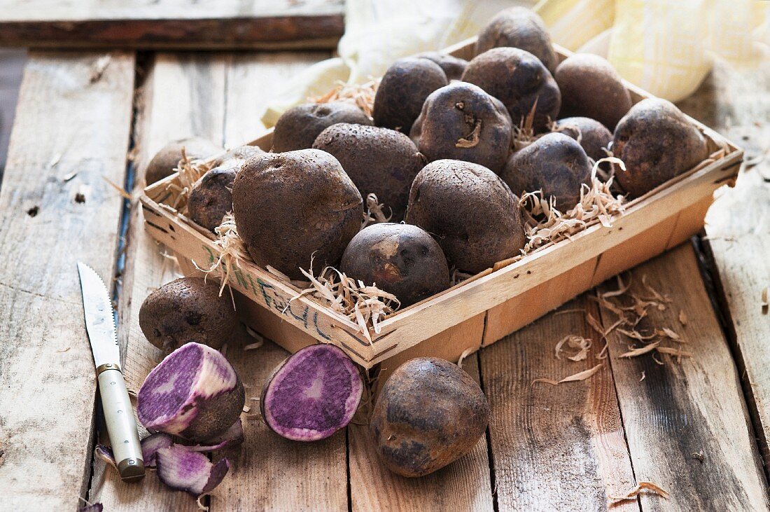 Purple potatoes in a wooden basket