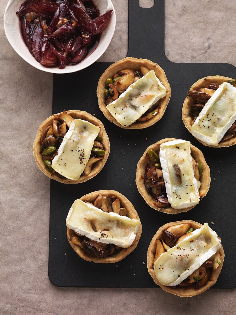 Mushroom tartlets gratinated with Brie and served with a shallot and port wine confit