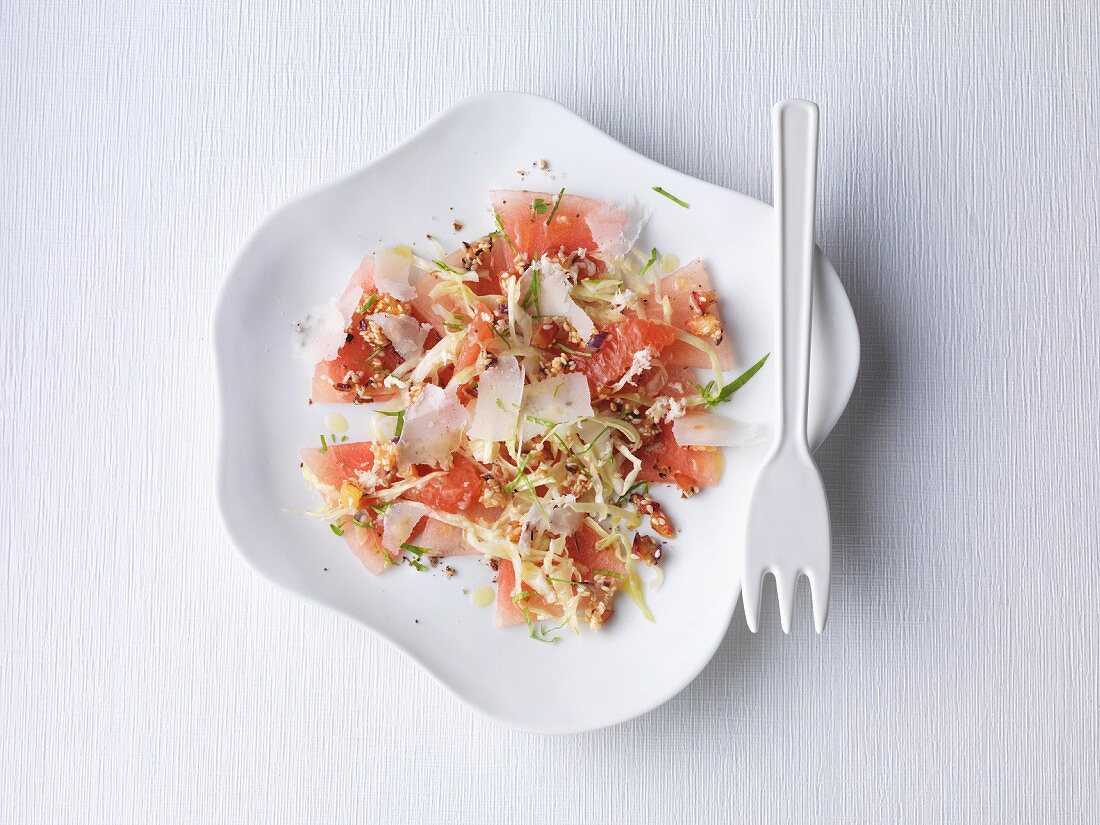 Watermelon carpaccio with raw pointed cabbage and fresh Parmesan cheese