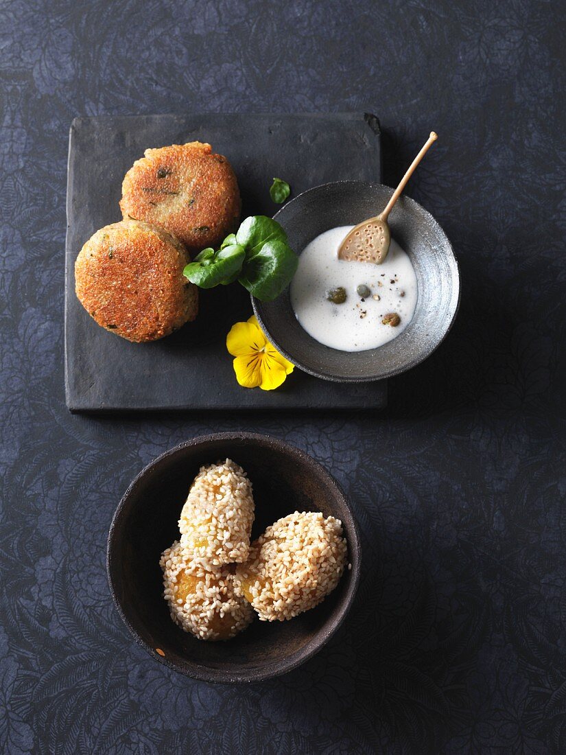 Caper sauce served with vegetarian green spelt fritters and sesame seed potatoes