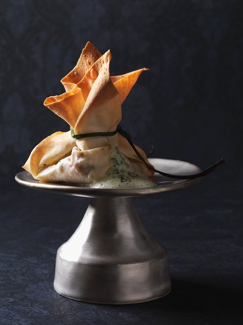 Fresh chanterelle mushrooms in a yufka pastry parcel with a herb and white wine sauce