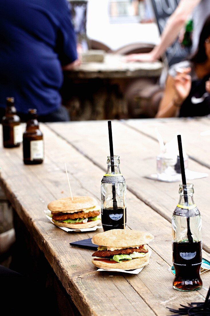 Burgers with cola on a wooden table