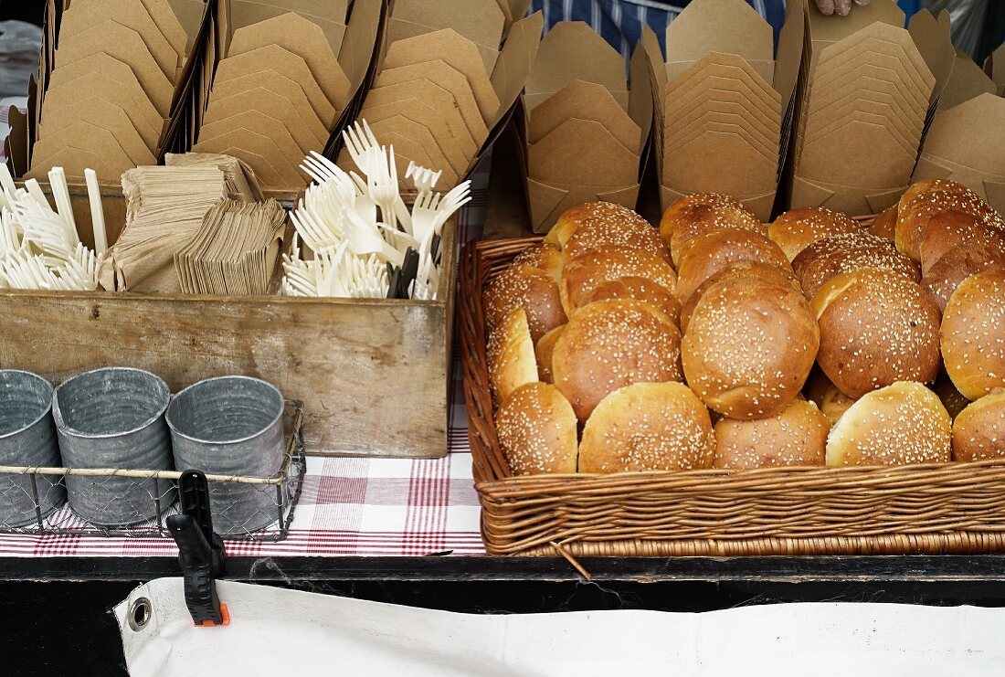 Sesame seed rolls, cardboard boxes and cutlery in a street kitchen (Covent Garden, London)