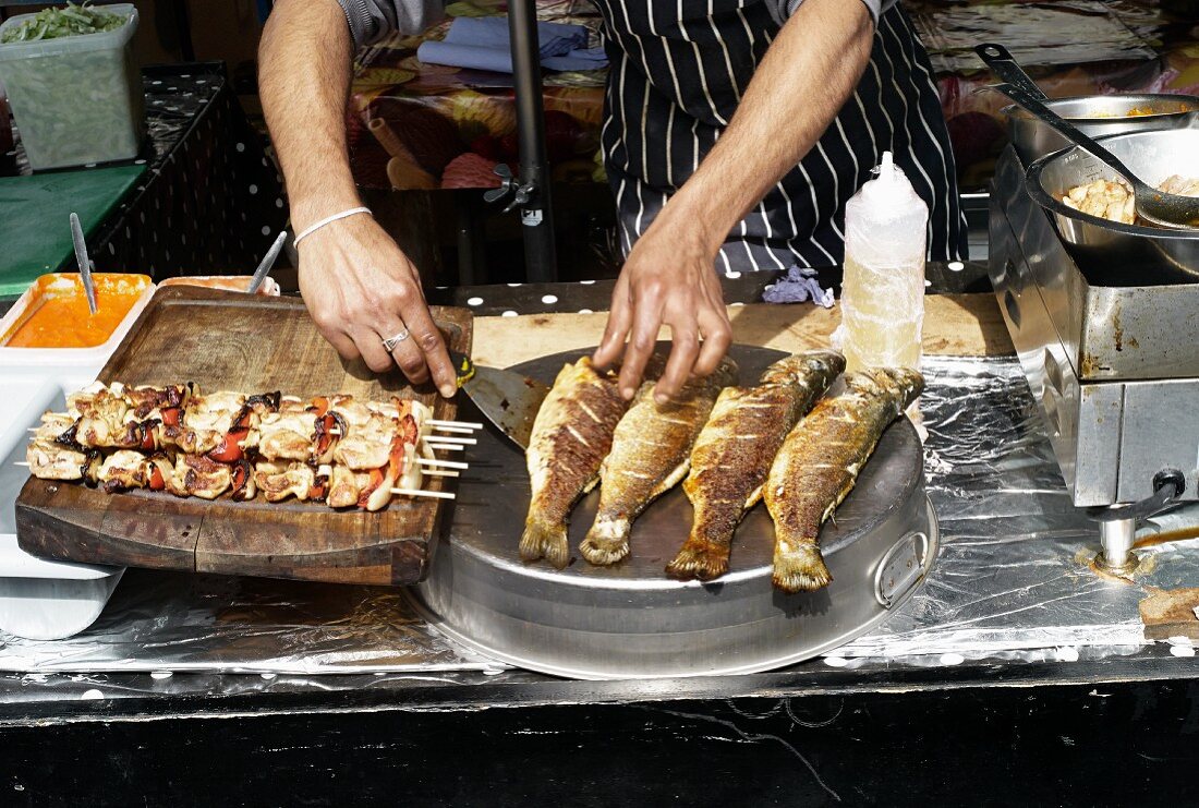 Fried fish and skewers in a street shop at a market (Covent Garden, London)