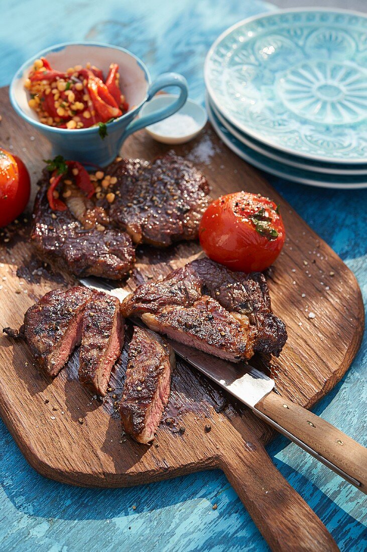 Grilled rib-eye steaks with tomatoes and lentils
