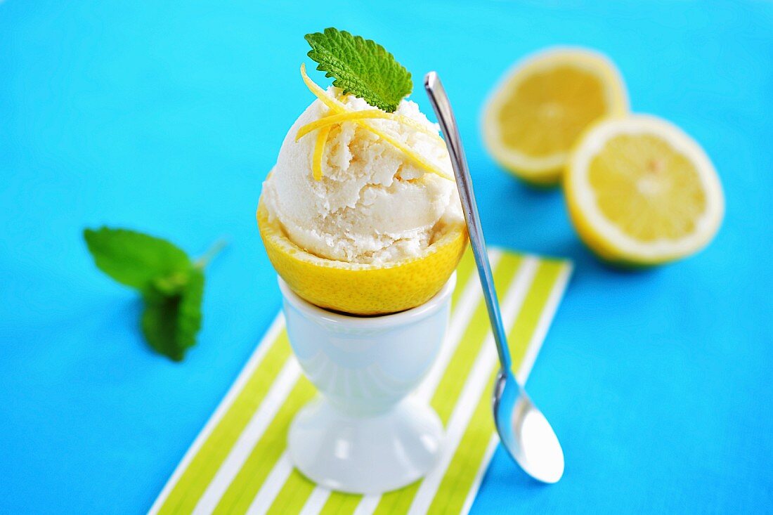 Lemon ice cream served in a hollowed out lemon in an egg cup