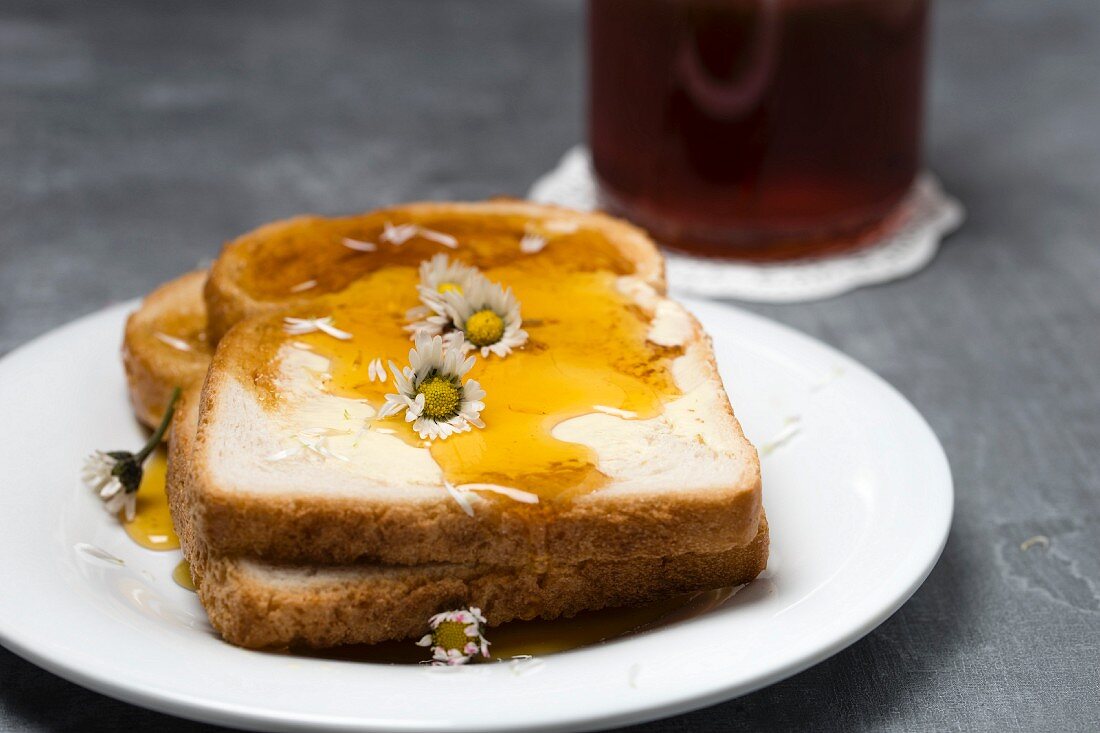 Slices of toast with honey and daises