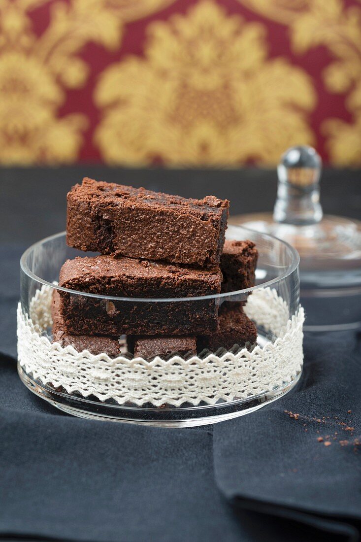 Brownies in a glass bowl decorated with a lace border