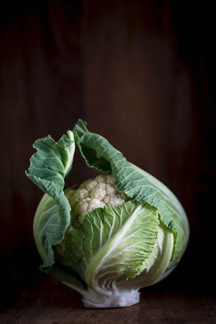 A cauliflower on a wooden table