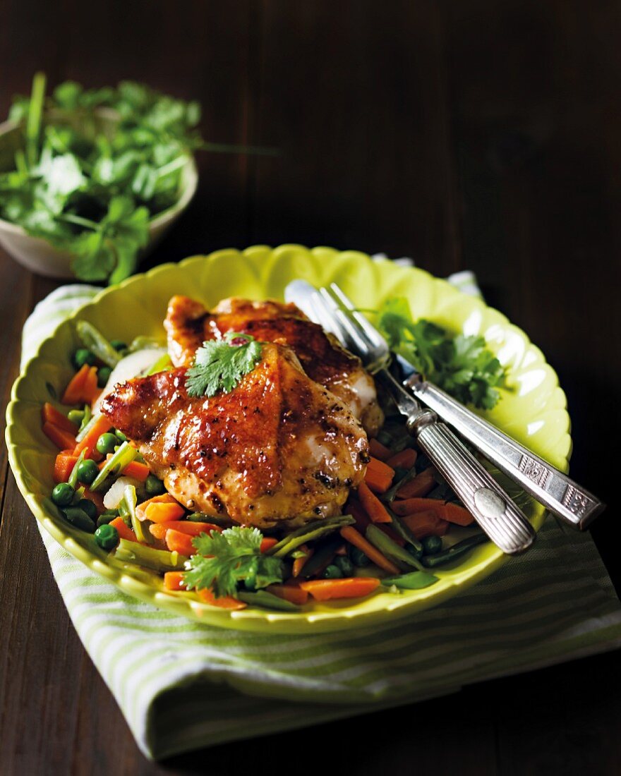 Roast chicken bits on a bed of fried vegetables