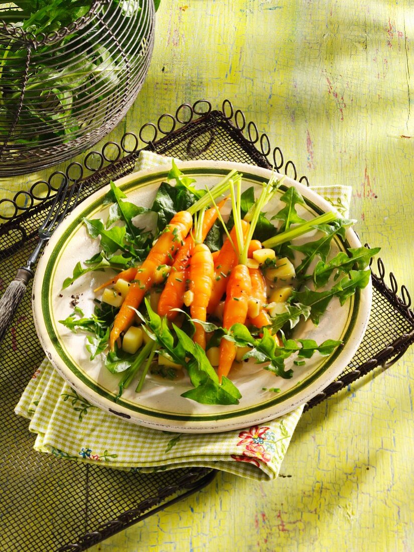 A salad of baby carrots, dandelions and potatoes